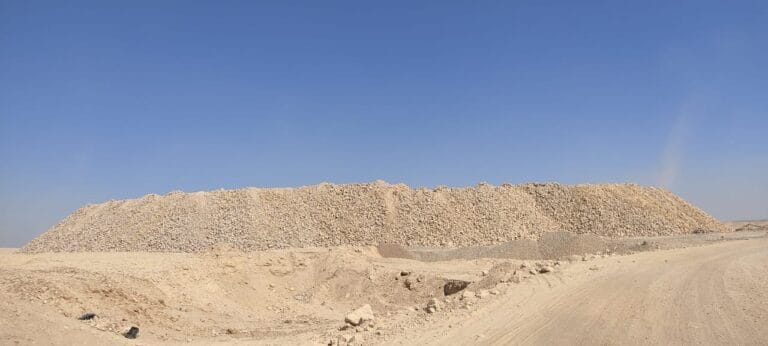 Egyptian phosphateCompany - Large pile of phosphate rock under a clear blue sky