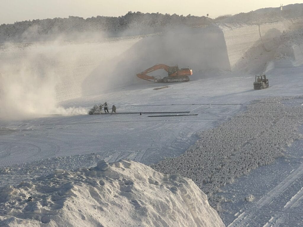 Talc Powder and Feldspar Company - Calcium carbonate quarry with heavy machinery and workers.